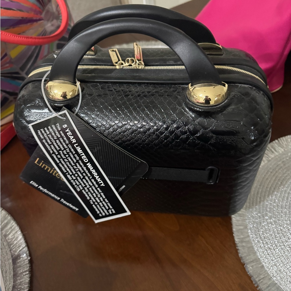 Black cosmetic with zipper and gold accents on bag